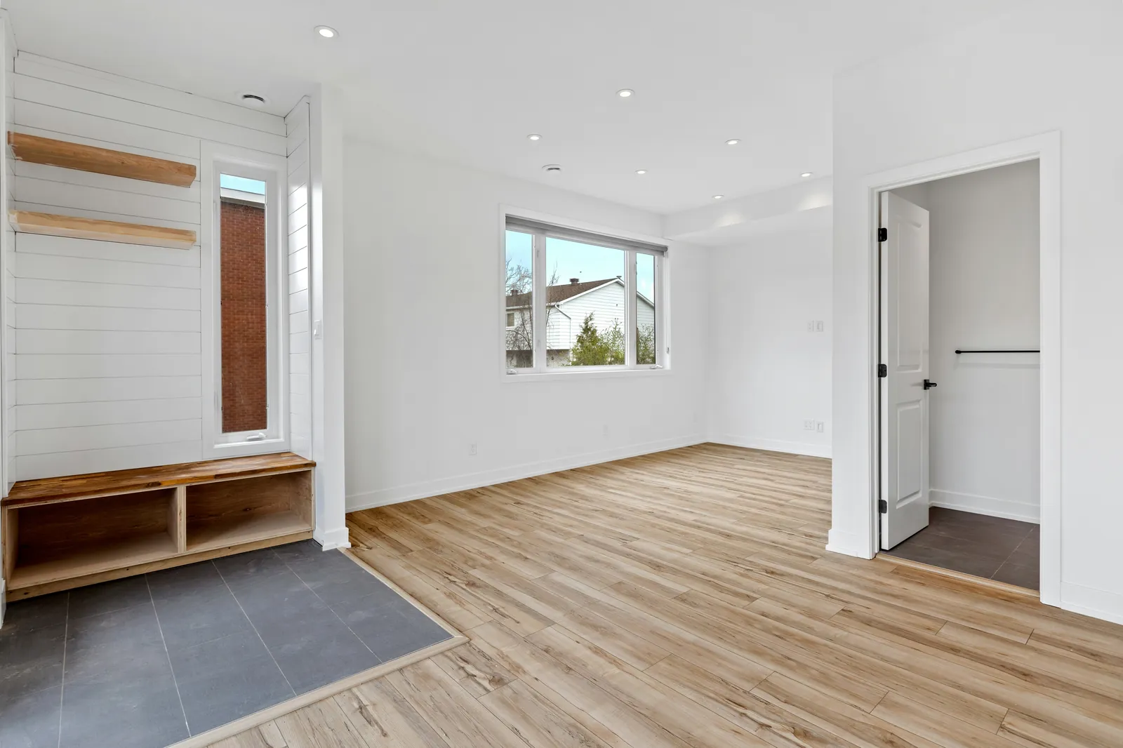 Bright empty room with freshly painted white walls, trim, doors, and ceiling.